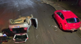 Carro bate em veículo estacionado e capota